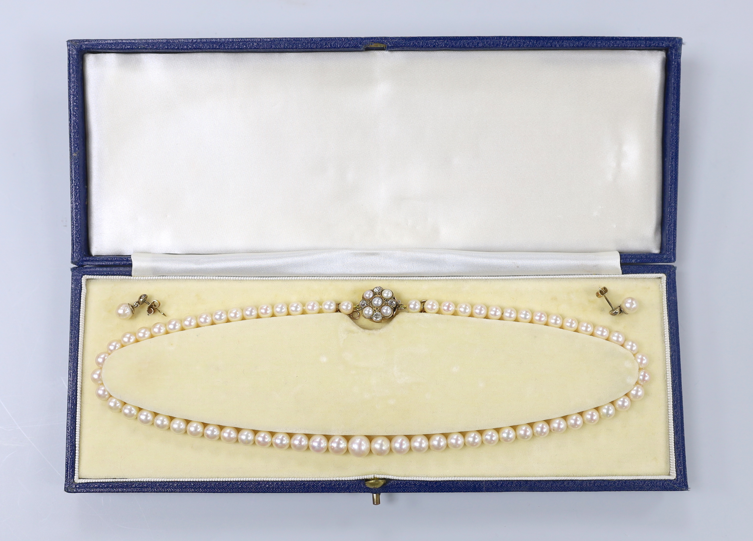 A single strand graduated cultured pearl necklace, with cultured pearl and diamond set yellow metal clasp, 44cm and a pair of yellow metal and cultured pearl set drop earrings.